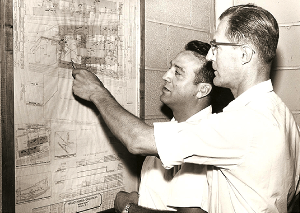 Picture of Joseph Mancuso working with his associate on a plan
